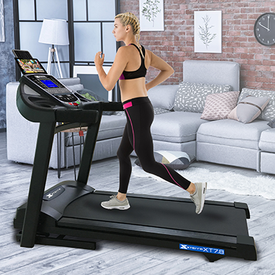 Woman with blonde hair running on the Xterra XT7.8 treadmill